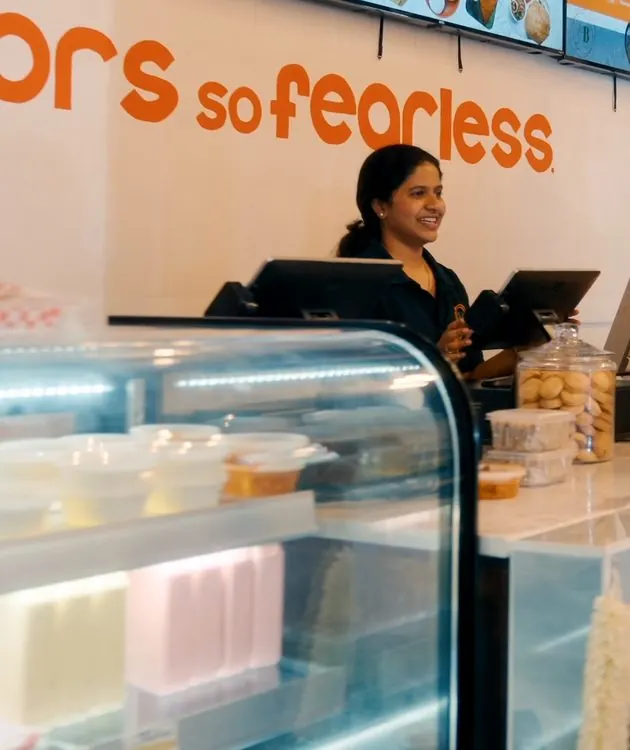 Bindaas Denton team serving a guest at the counter